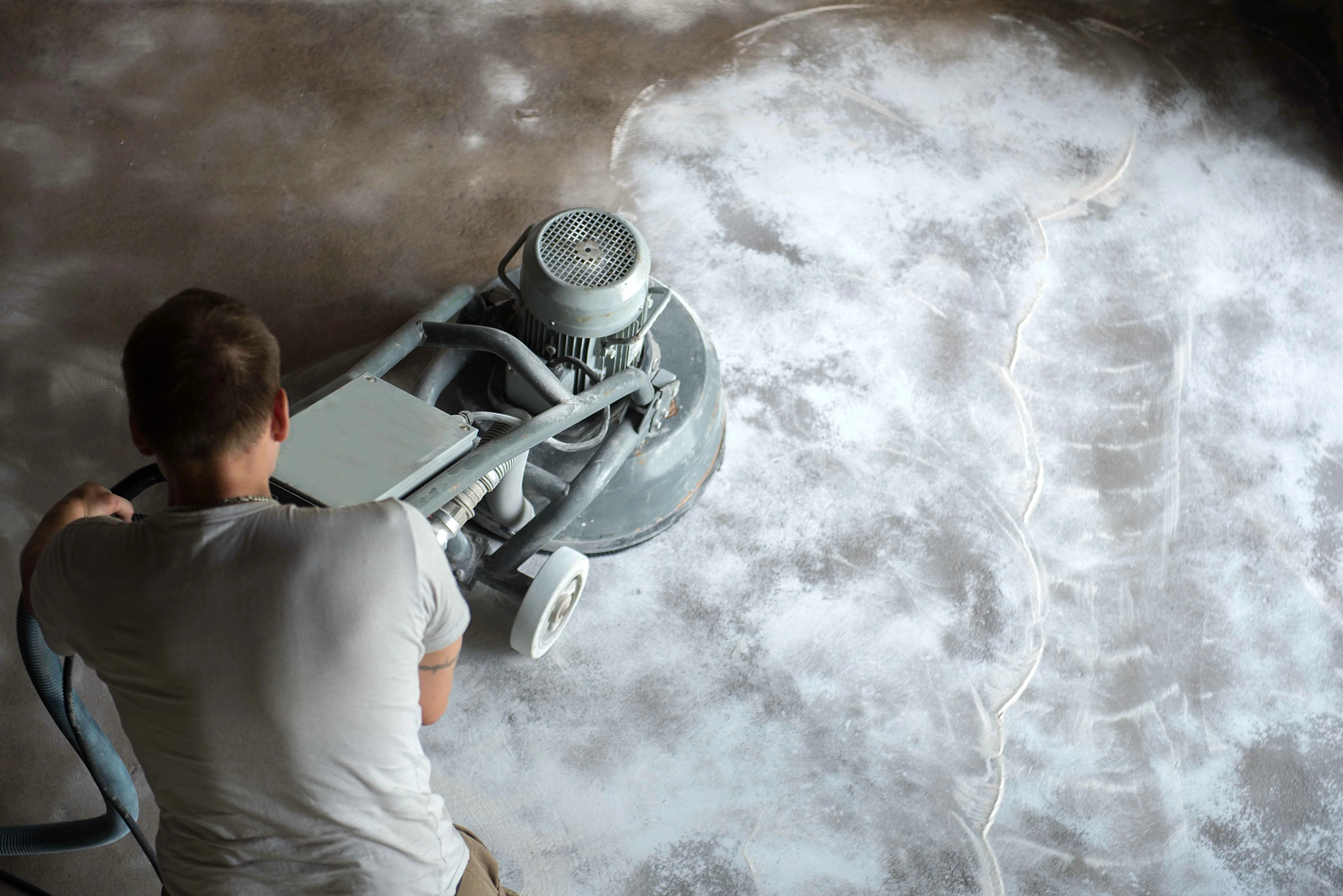 Concrete grinding and surface preparation before floor coating installation